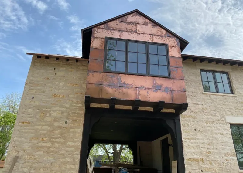 Copper metal panel facade on a stone building for Skylight Installation in Beaumont